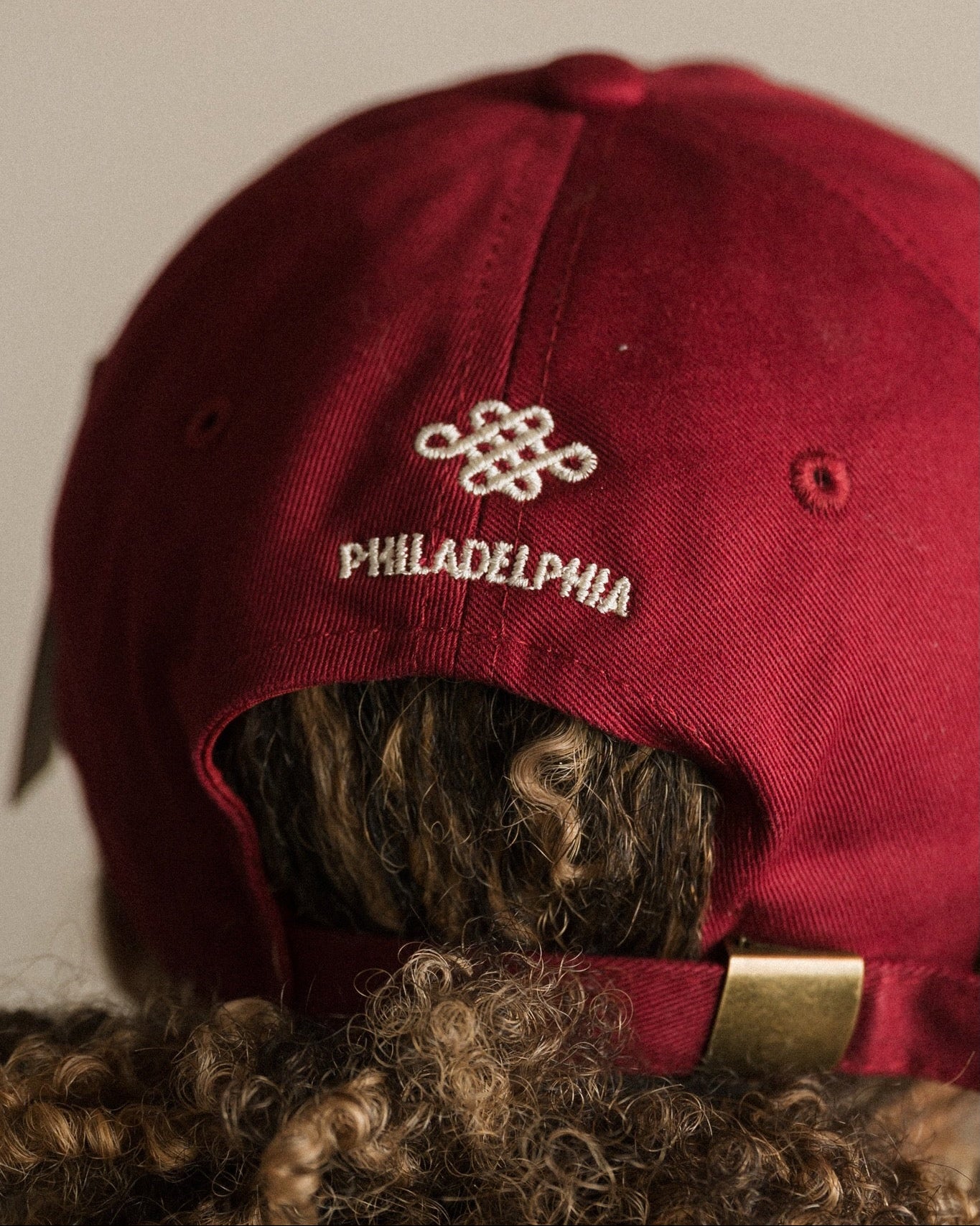 Red cap with 'Philadelphia' logo on the back against a plain background