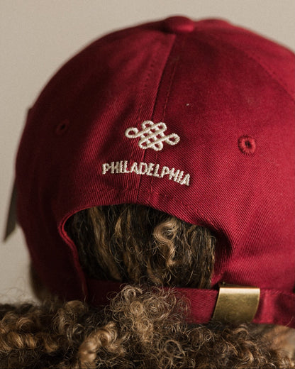 Red cap with 'Philadelphia' logo on the back against a plain background